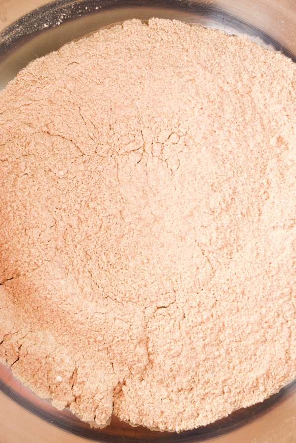 Overhead view of spelt flour in a big metal bowl