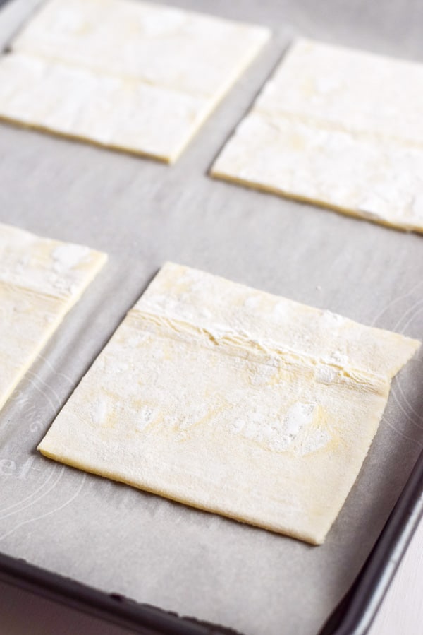 Cut squares of puff pastry on a parchment paper lined pan