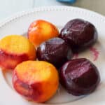 A white beaded plate with three red and three yellow beets - square