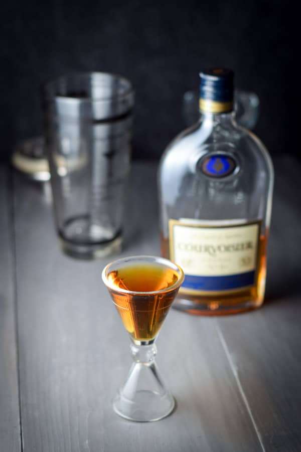 Cognac measured out with the cocktail shaker and bottle in the background