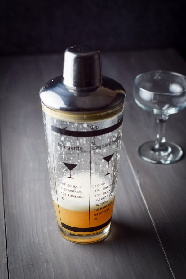 The cocktail shaken and the coupe glass off to the right