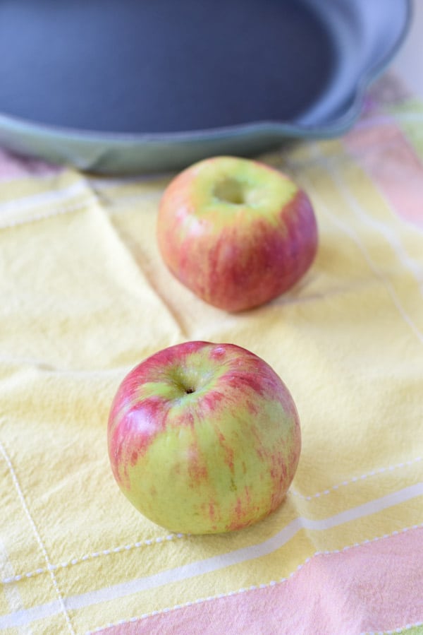 Two apples and a cast iron skillet