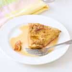 A plate with the pancake with a bite taken out of it - square