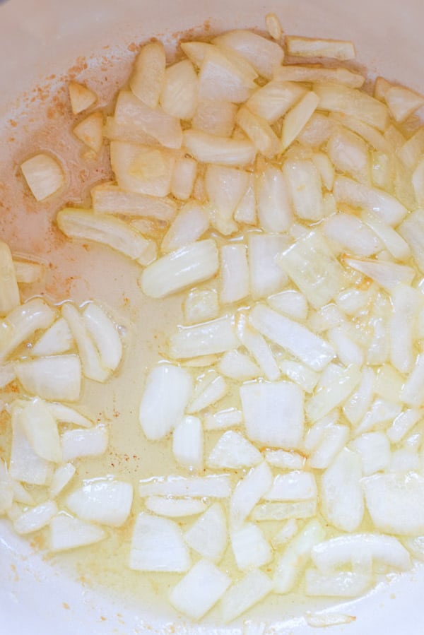Butter and onions sautéed in an enamel pan