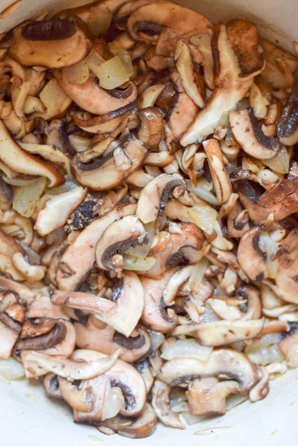 Mushrooms are added to the onion and sautéed together