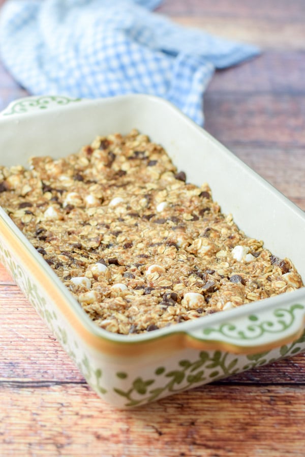 The granola bars packed into a baking dish ready to be baked