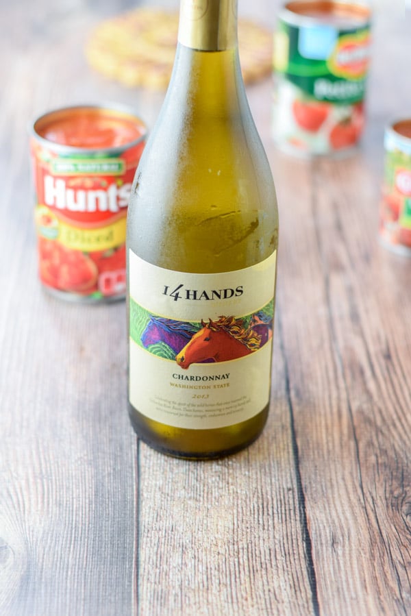 Wine, diced tomatoes on a wooden table