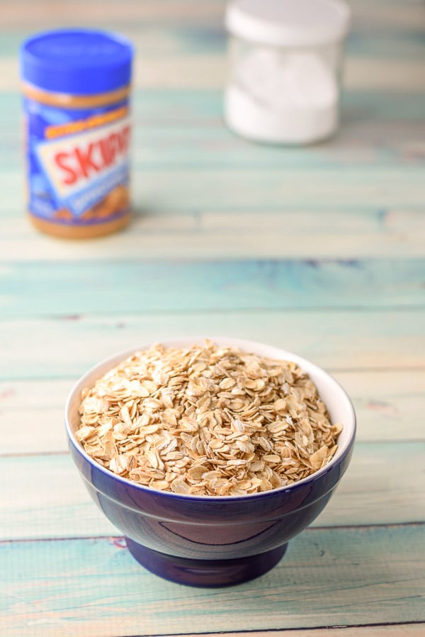 Oatmeal in a blue bowl, peanut butter and baking soda on the table
