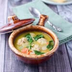 Two brown crocks filled with the meatball soup - square