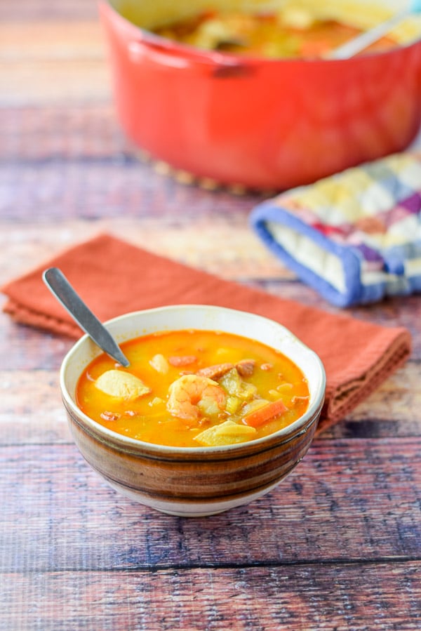 A bowl of soup in a brown bowl