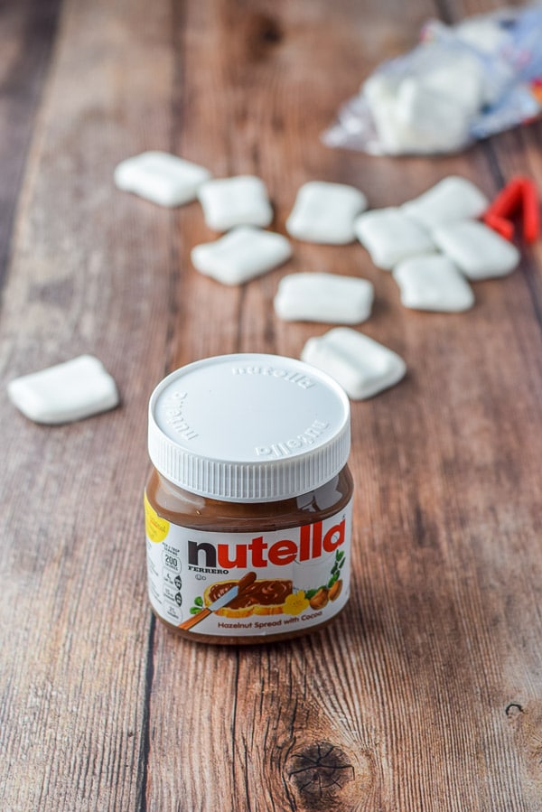 Nutella and marshmallows on a wooden table