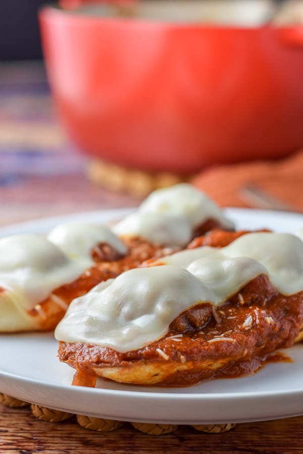 Vertical view of the bread with sauce, meatballs and melted cheese with a pan in the background