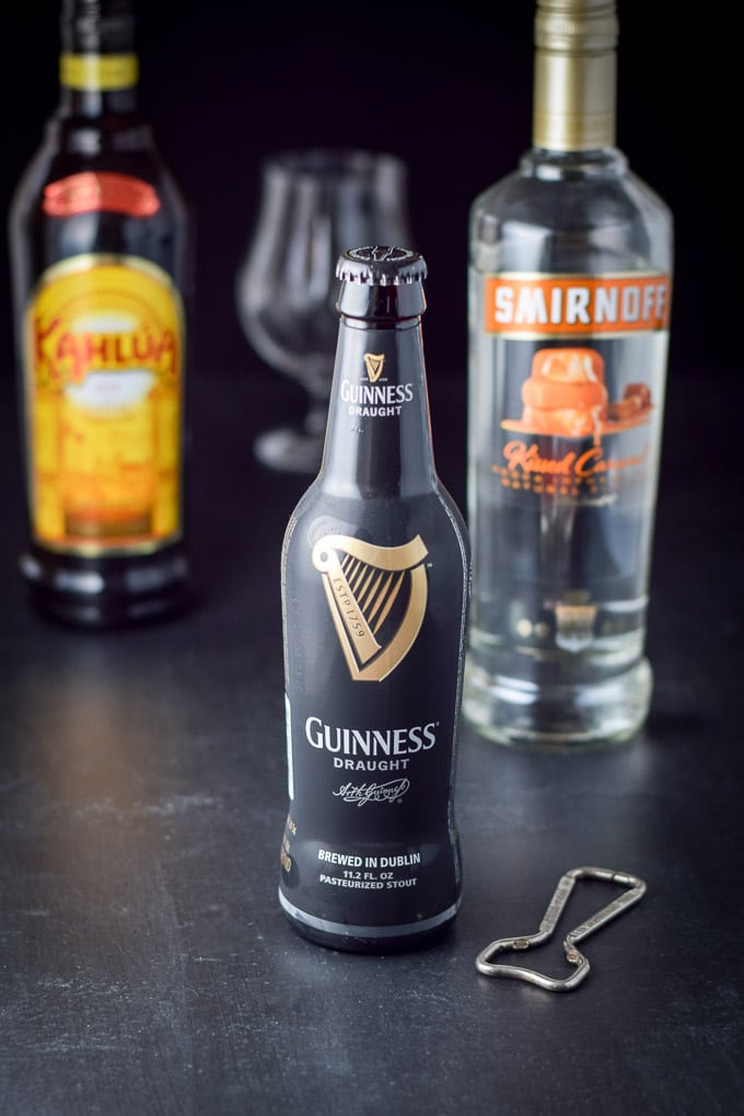 Guinness, caramel vodka and kahlua with a glass in the background