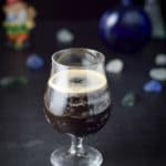 A curved beer glass filled with the Guinness cocktail