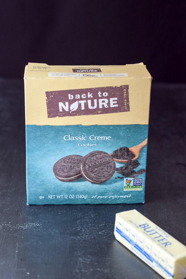 Chocolate creme cookies and butter on a black table