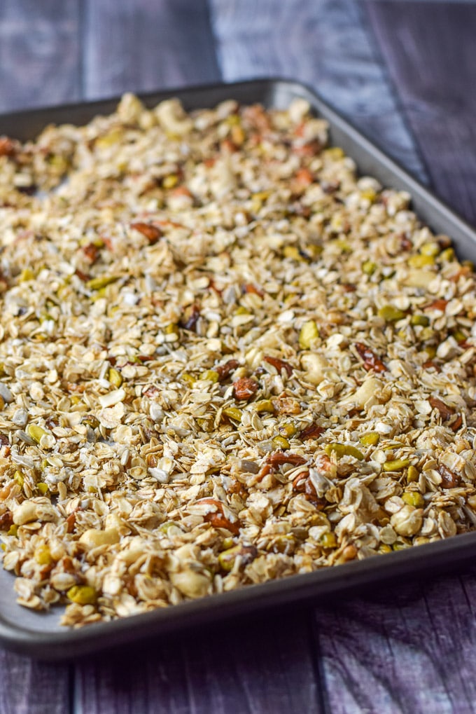 All the granola ingredients mixed and on the pan covered with parchment paper