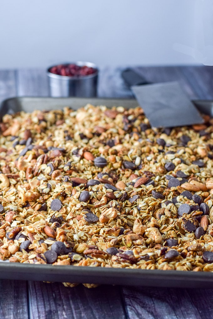 Chocolate added to the granola on the pan ready to be mixed together