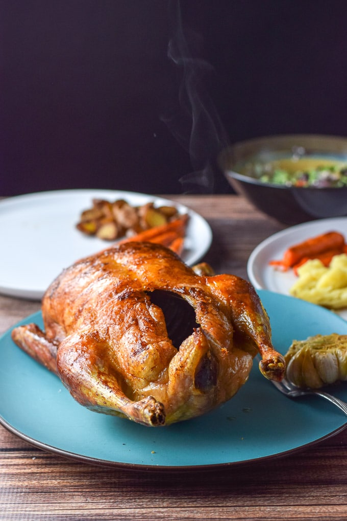 Duck straight out of the oven and on a blue platter with steam rising off it