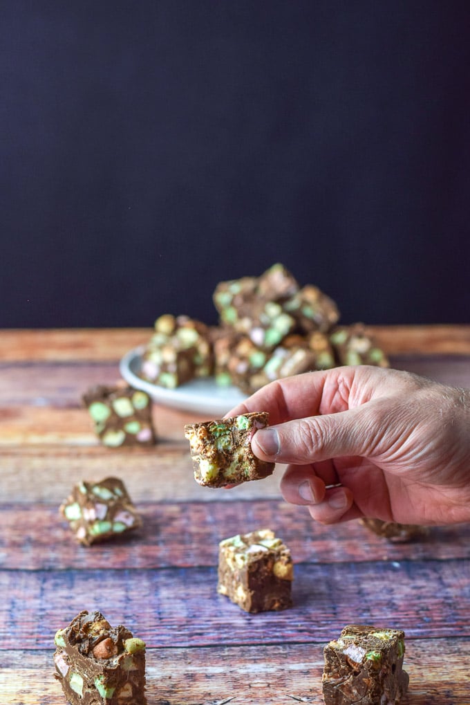 A bite taken out of the fudge with some pieces strewn on the table