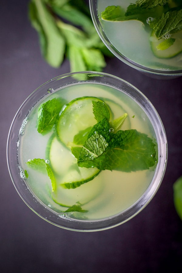 Overhead shot of the martinis with cucumbers and mint floating in them