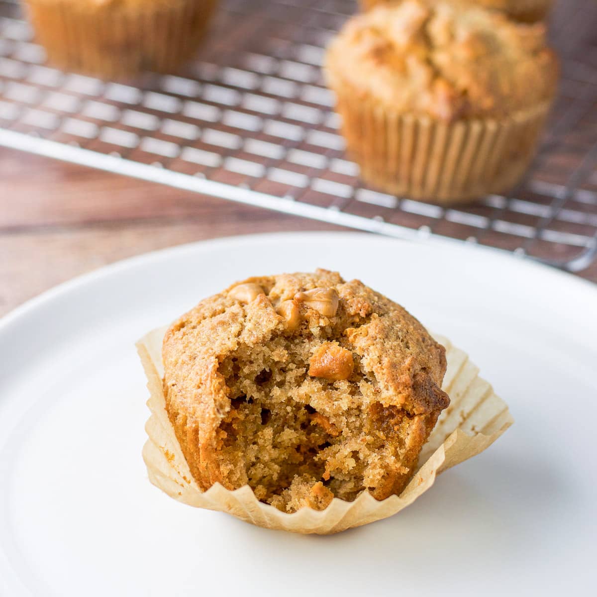 A muffin with a bite out of it on a white plate
