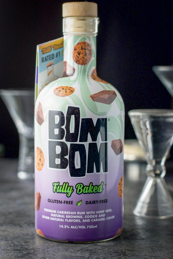Bom Bom fully baked in the forefront with glasses and measuring glass