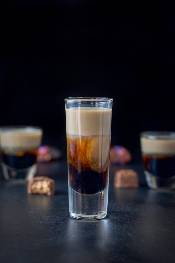 Tall glass filled with the snickers shot looking delicious Tall glass filled with the snickers shot looking delicious