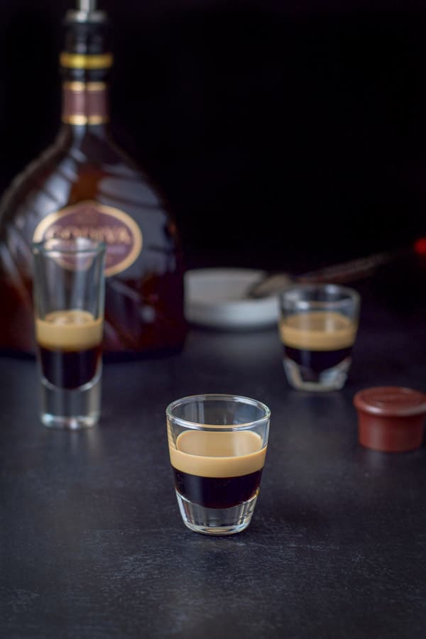 chocolate liqueur layered in the three glasses with the bottle in the background