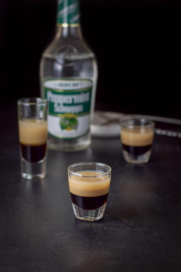 peppermint schnapps layered in with the bottle and spoons in the background