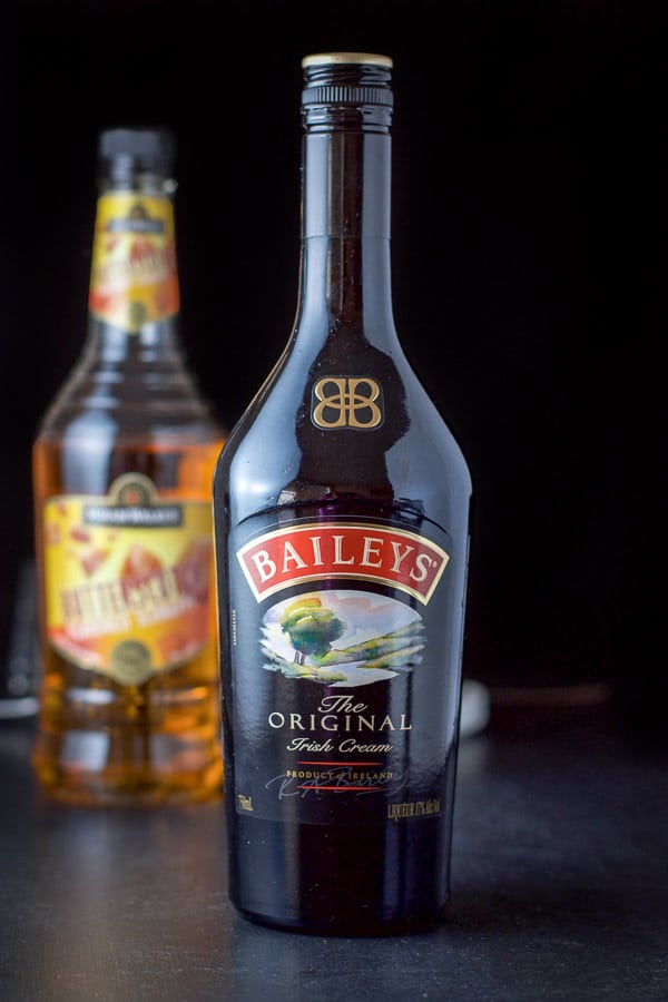 Baileys and butterscotch schnapps on a black table