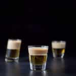 The two layered shot in the beveled glass in front of the other two glasses- square