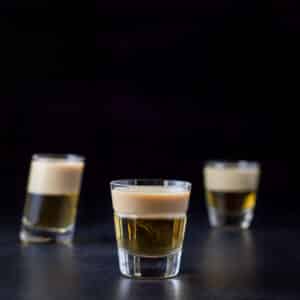 The two layered shot in the beveled glass in front of the other two glasses- square