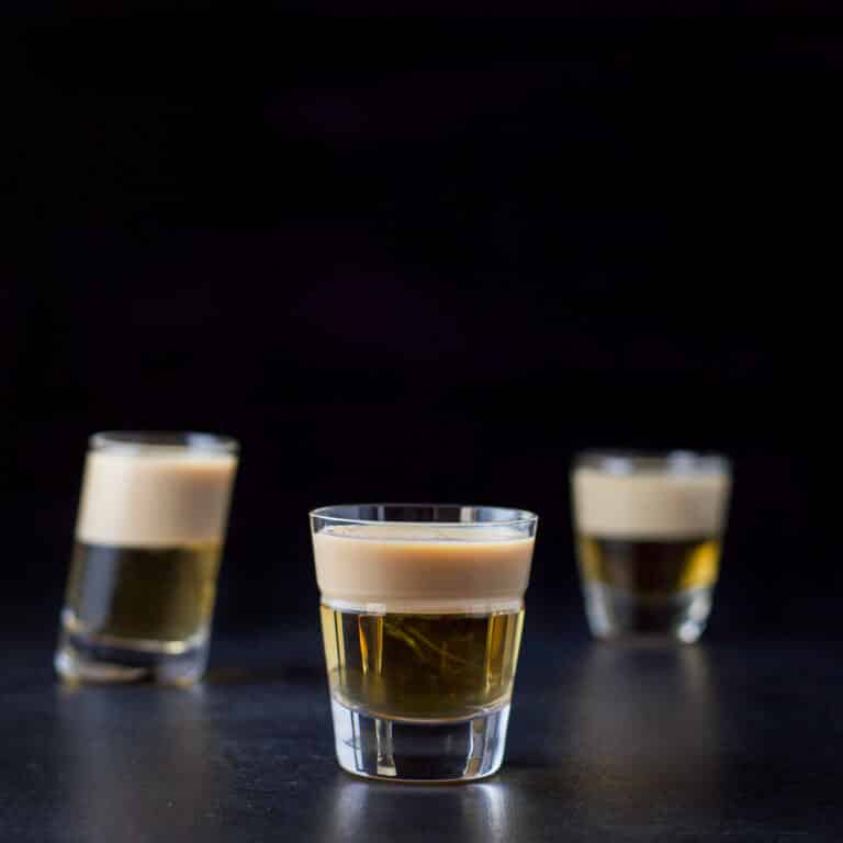 The two layered shot in the beveled glass in front of the other two glasses- square