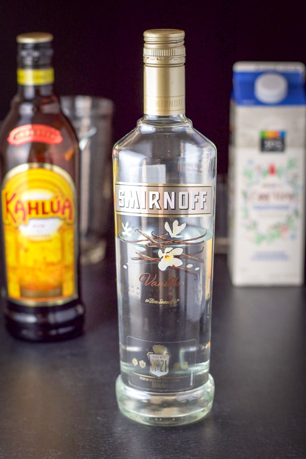 Smirnoff, Kahlúa, eggnog on the board with the shaker in the background