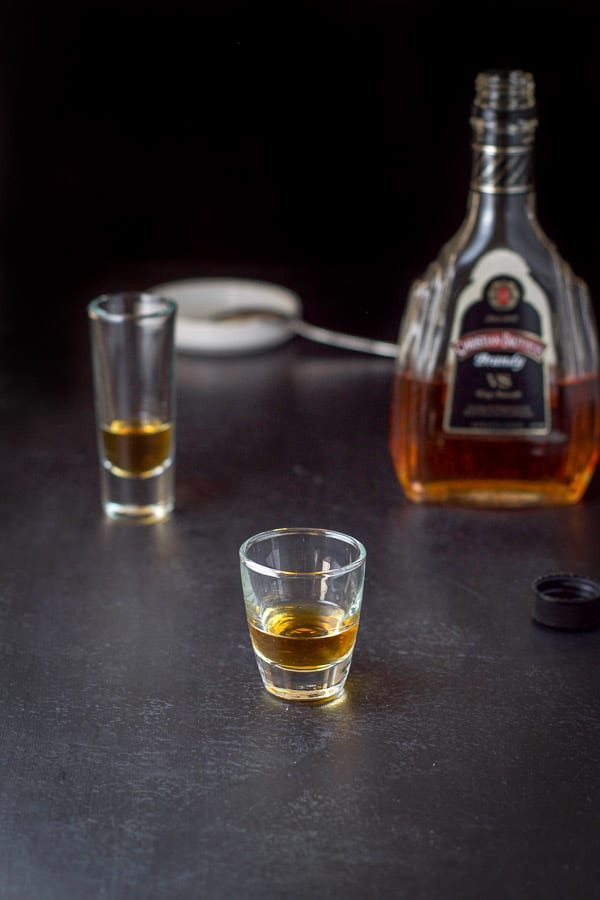 Brandy poured in the glasses with the bottle in the background