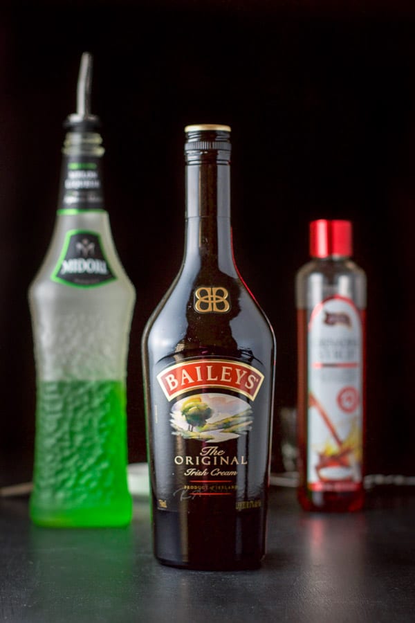 Baileys Midori and grenadine on a black board