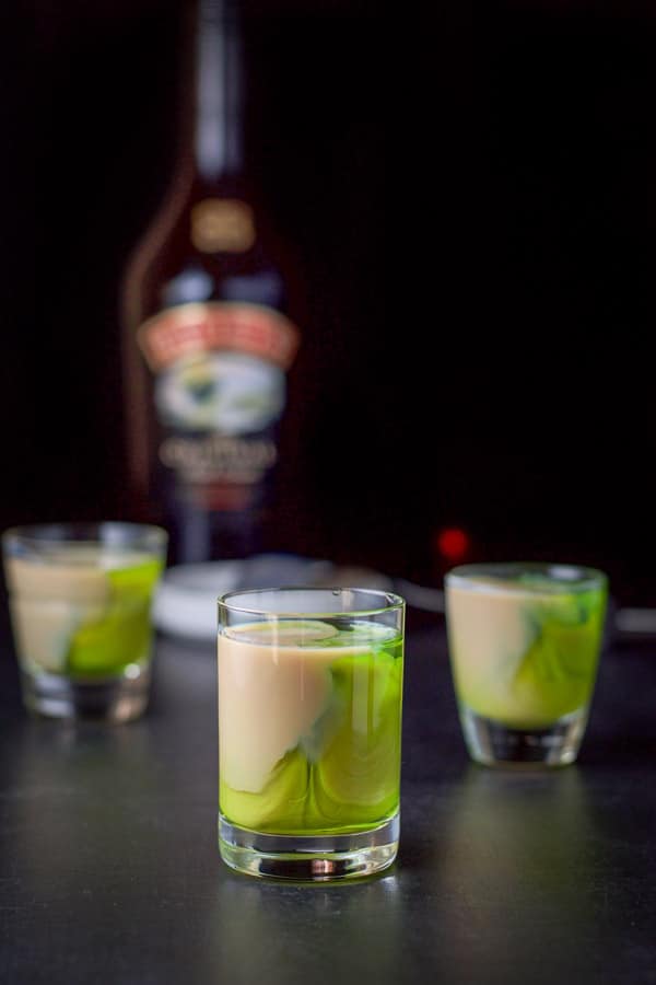 Baileys layered into the glasses with the bottle in the background