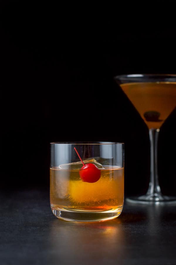 Vertical view of the short glass with a red cherry and the cocktail