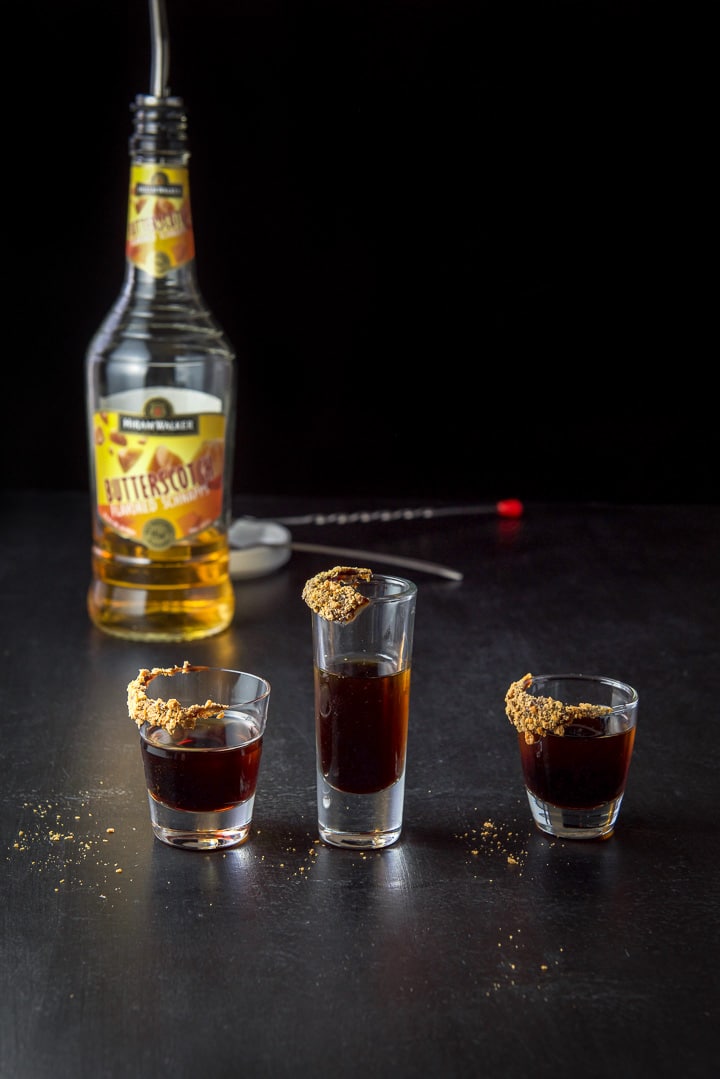 Butterscotch schnapps three layered shot glasses with the bottle in the background