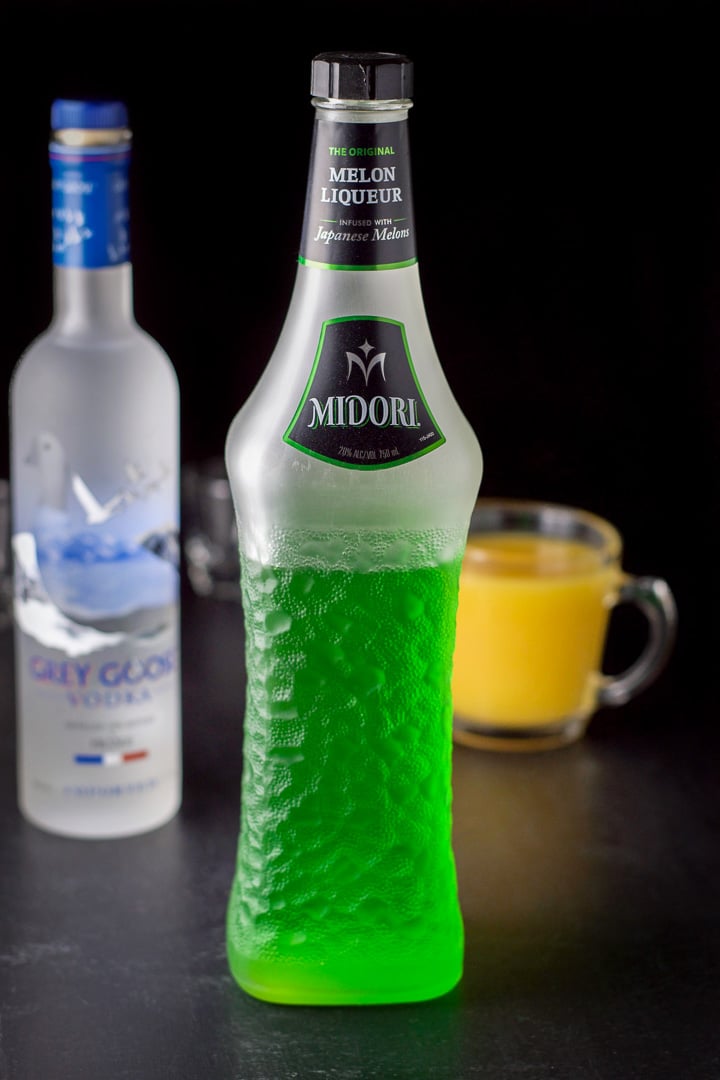 Midori, Grey Goose and orange juice on a black board