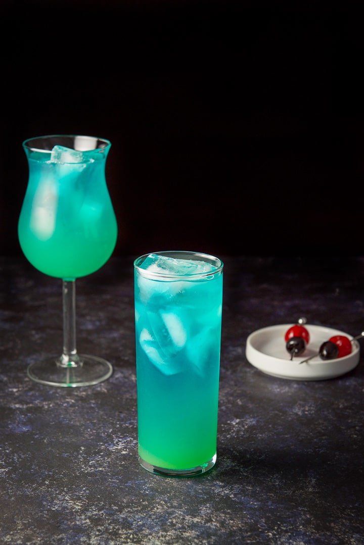 Pineapple juice poured into the glasses with the garnish in the background