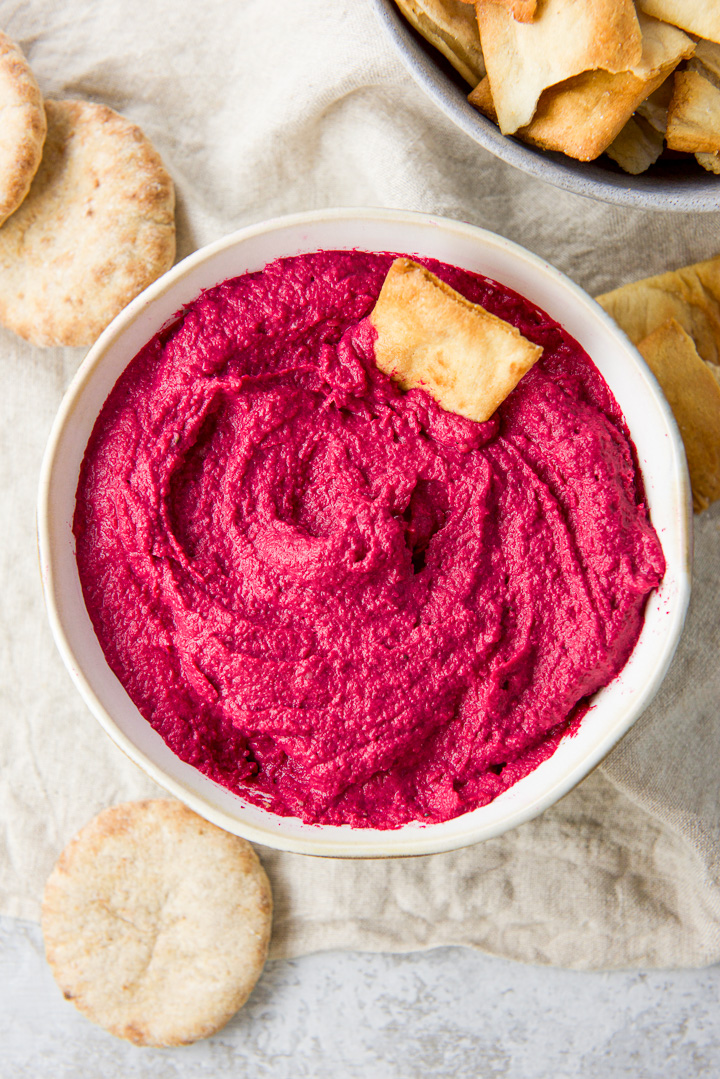 Overhead view of the pita chip dipped in the beet hummus