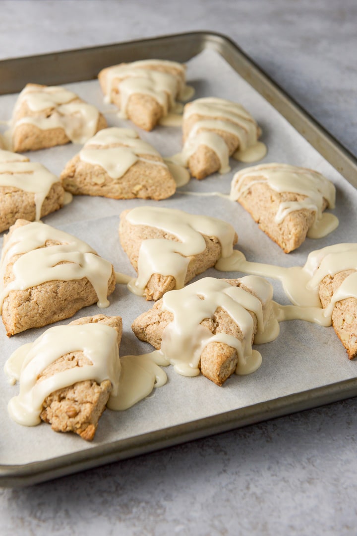 Glaze drizzled on the scones in the pan