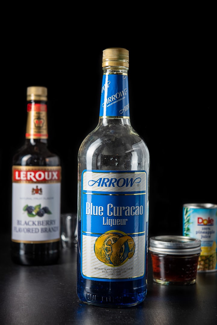 Blue Curacao, blackberry brandy and pineapple juice on the table
