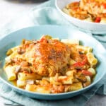 Square photo of two bowls with the chicken cacciatore on pasta