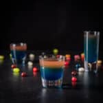 Square of the vertical view of the beveled glass in front of the two other glasses ad jelly beans on the table