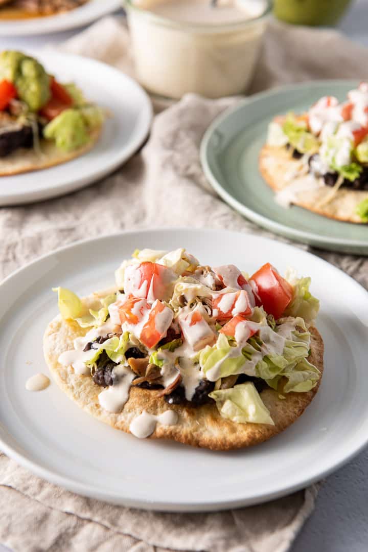 Close up of a pork tostadas with crema on top