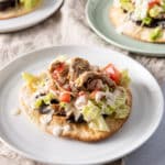 Pulled pork on top of one of the tostadas - square