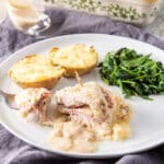 A forkful of baked cordon bleu on a plate - square