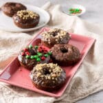 A pink plate of baked chocolate donuts - square